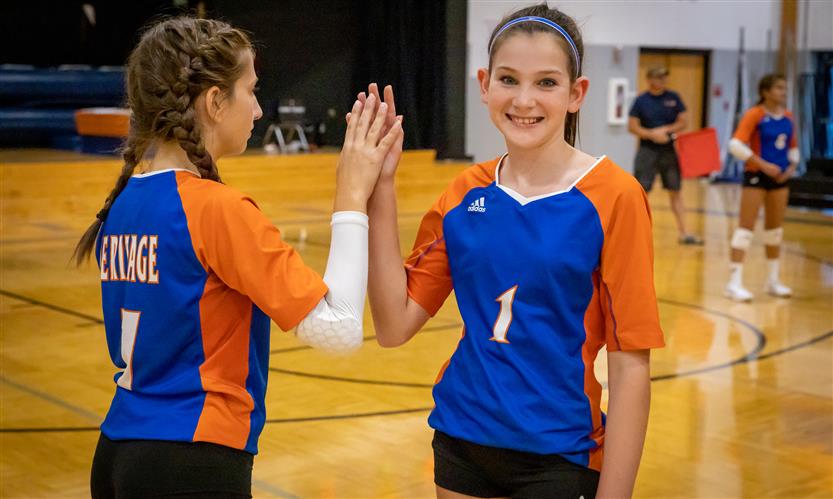Two volleyball players prepare to substitute out